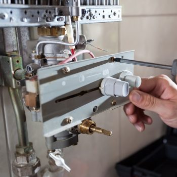 Gas water heater reparation Close-up of a gas water heater reparation